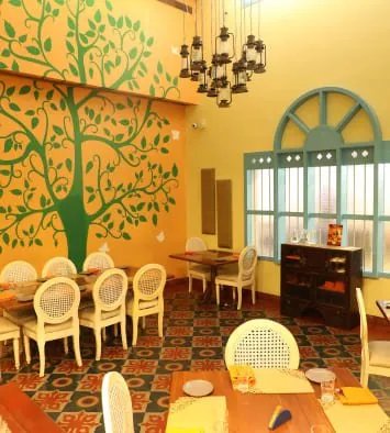 Fresh Restaurant interior with tree mural